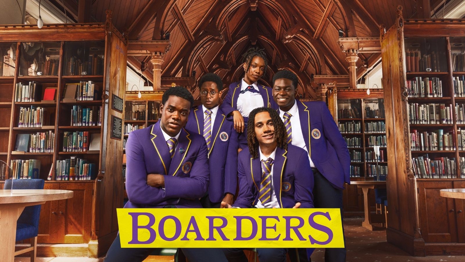 The cast of Boarders in an old library