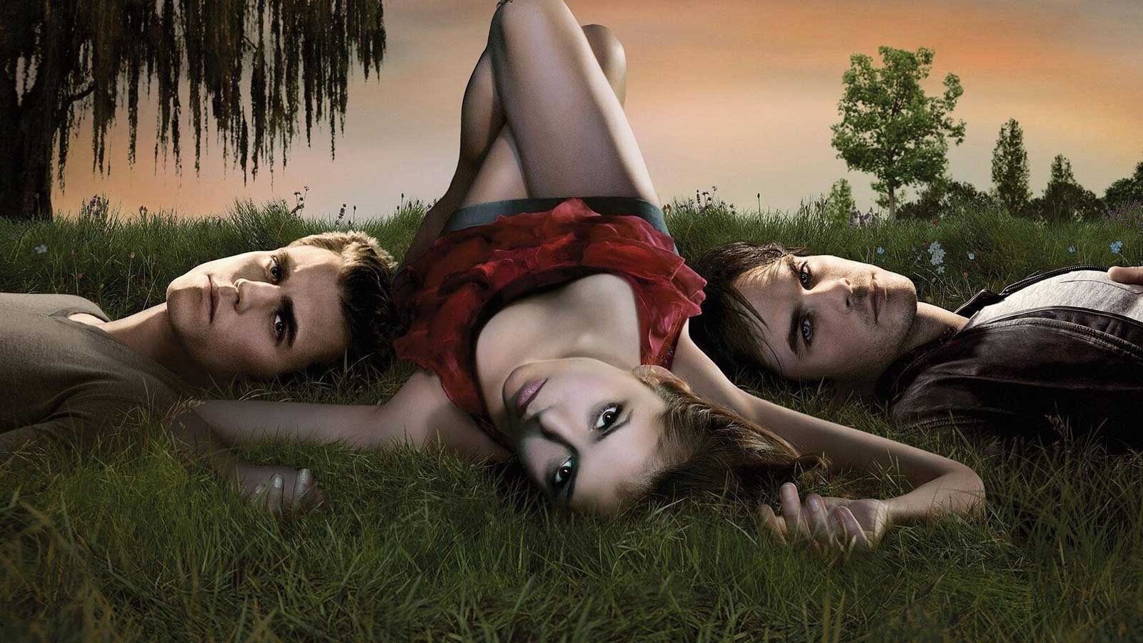 Ian Somerhalder, Nina Dobrev and Paul Wesley lying on the grass in Vampire Diaries